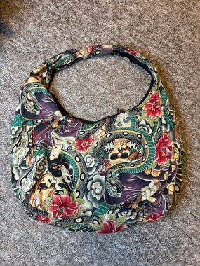 The Alexander Henry “Zen Charmer” tattoo flash print hobo shoulder bag